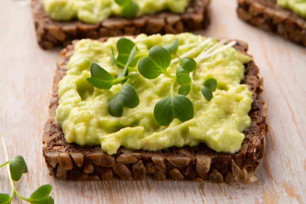 Microgreens as garnish on an avocado whole grain sandwich